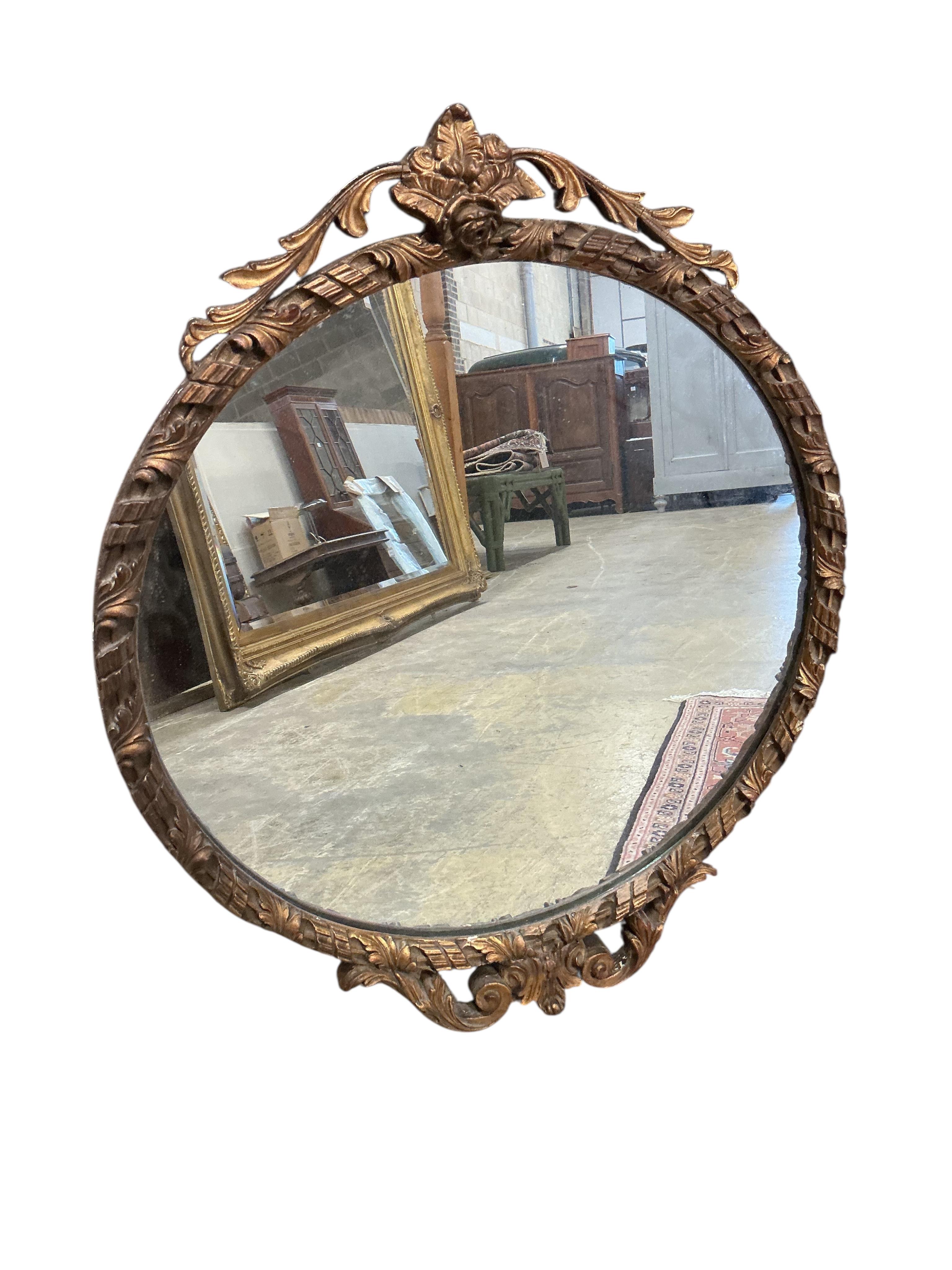 An early 20th century giltwood convex wall mirror, diameter 56cm together with one other circular wall mirror